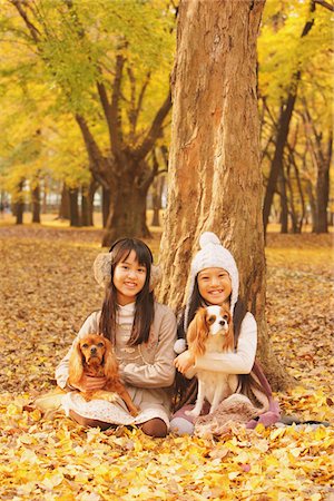 Girls Holding Their Dog In Leaves Stock Photo - Rights-Managed, Code: 859-03839400