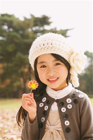 Pretty Girl Holding Flower Stock Photo - Rights-Managed, Code: 859-03839628