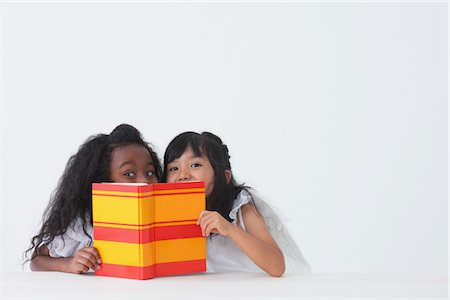 emotion - Girls Hiding Behind A Book Stock Photo - Rights-Managed, Code: 859-03839786