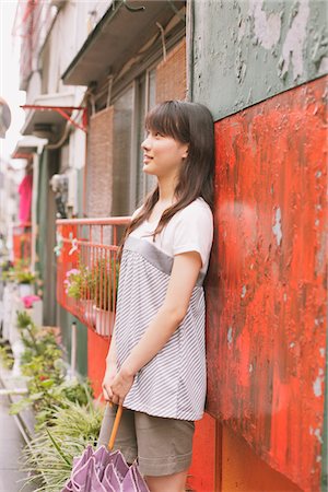 simsearch:859-03983201,k - Young adult woman Leaning against wall Stock Photo - Rights-Managed, Code: 859-03840056