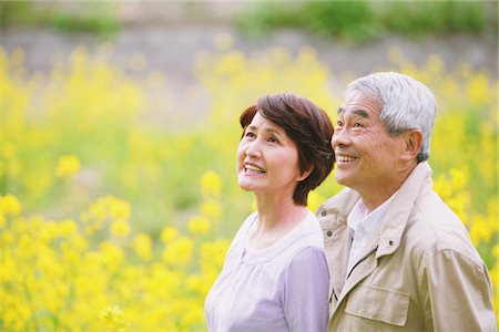 Middle-Aged Couple Standing In Field Of Yellow Flowers Stock Photo - Rights-Managed, Code: 859-03840375