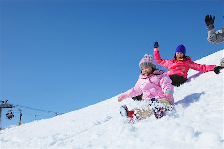 sliding - Parents And Their Daughter Sliding In Snow Stock Photo - Rights-Managed, Code: 859-03840635