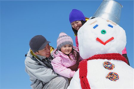 Parents With Their Daughter Making Snowman Stock Photo - Rights-Managed, Code: 859-03840666
