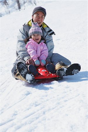Father And Daughter sledging In Snow Stock Photo - Rights-Managed, Code: 859-03840704