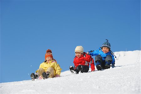 simsearch:859-03840695,k - Children Sliding Downward Together In Snow Stock Photo - Rights-Managed, Code: 859-03841004