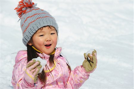 people playing in the snow - Small Girl Holding Snowball Stock Photo - Rights-Managed, Code: 859-03841014