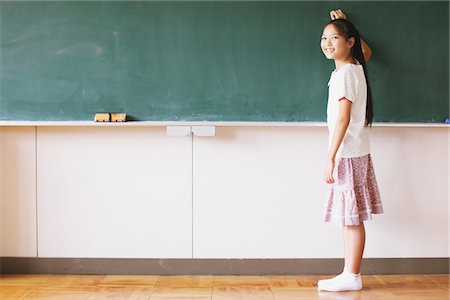 preteen asian girls - Schoolgirl Writing On Chalkboard Stock Photo - Rights-Managed, Code: 859-03860820