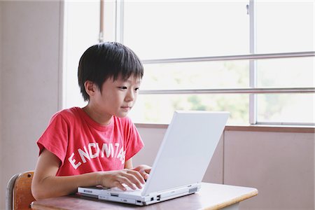 school boys side - Boy Using Laptop In Classroom Stock Photo - Rights-Managed, Code: 859-03860917