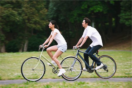 fitness asian couple - Japanese Couple Riding Bicycles In park Stock Photo - Rights-Managed, Code: 859-03884514