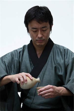sake - Japanese man holding a Sake bottle Stock Photo - Rights-Managed, Code: 859-03884612