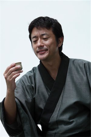 sake - Japanese man holding a Sake cup Stock Photo - Rights-Managed, Code: 859-03884613