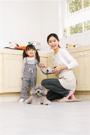 purebred - Mother And Daughter In Kitchen With Poodle Dog Stock Photo - Rights-Managed, Code: 859-03884846