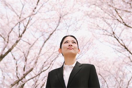 Businesswoman Standing Under Cherry Blossom Tree Stock Photo - Rights-Managed, Code: 859-03884970