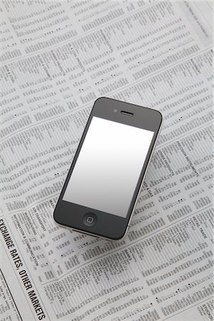 Apple iPhone  On Newspaper Stock Photo - Rights-Managed, Code: 859-03982595