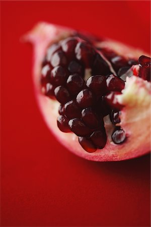 punica granatum - Close Up Of Pomegranate On Red Background Stock Photo - Rights-Managed, Code: 859-03983061