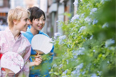 Two Young Women Wearing Yukata Looking By Flower Plants Stock Photo - Rights-Managed, Code: 859-03983227