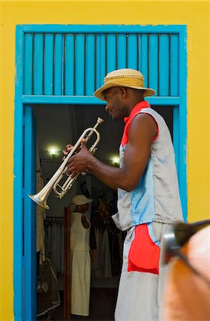 picture of the blue playing a instruments - A street entertainer playing a trumpet beside colorful doorway,Havana,Cuba Stock Photo - Rights-Managed, Code: 851-02959367