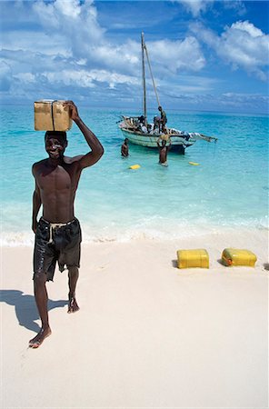Man carrying box on head on beach,Vamizi Querimbas,Mozambique Stock Photo - Rights-Managed, Code: 851-02961969