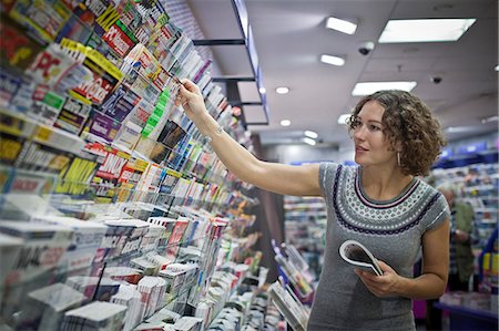 Woman in a magazine shop, main station, Munic, Bavaria, Germany, Europe Stock Photo - Rights-Managed, Code: 853-06120435