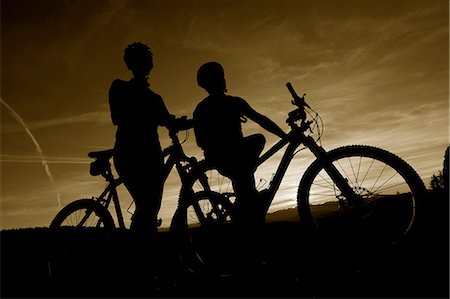 Two mountainbikers at dusk in the Dolomites, South Tyrol, Italy Stock Photo - Rights-Managed, Code: 853-06120446