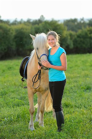 simsearch:853-06306120,k - Smiling girl with horse on meadow Stock Photo - Rights-Managed, Code: 853-06306077