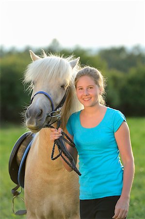simsearch:853-06306120,k - Smiling girl with horse on meadow Stock Photo - Rights-Managed, Code: 853-06306078