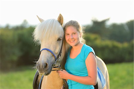 simsearch:853-06306120,k - Smiling girl with horse on meadow Stock Photo - Rights-Managed, Code: 853-06306079