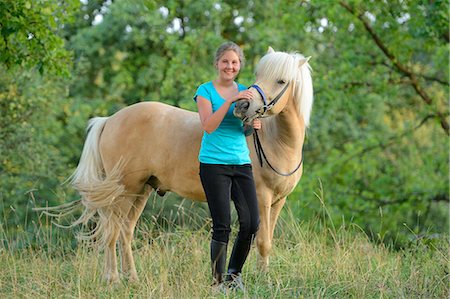 simsearch:853-06306120,k - Smiling girl with horse on meadow Stock Photo - Rights-Managed, Code: 853-06306086