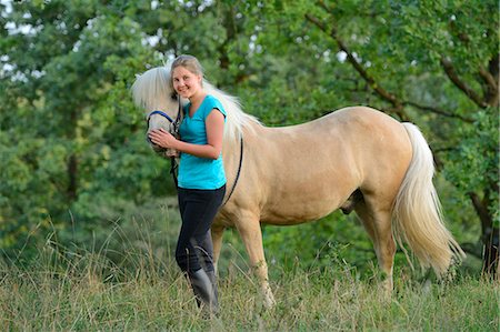 simsearch:853-06306120,k - Smiling girl with horse on meadow Stock Photo - Rights-Managed, Code: 853-06306087