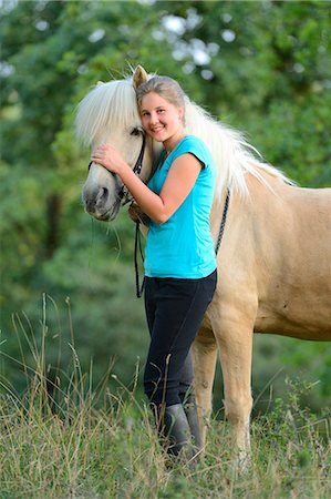 simsearch:853-06306120,k - Smiling girl with horse on meadow Stock Photo - Rights-Managed, Code: 853-06306088