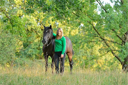 simsearch:853-06306120,k - Smiling teenage girl with horse on meadow Stock Photo - Rights-Managed, Code: 853-06306080