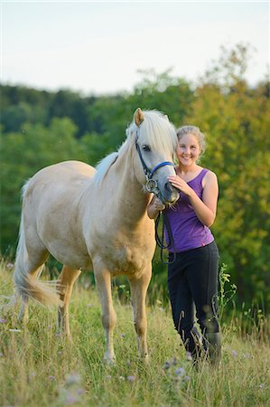 simsearch:853-06306120,k - Smiling girl with horse on meadow Stock Photo - Rights-Managed, Code: 853-06306119