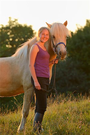 simsearch:853-06306120,k - Smiling girl with horse on meadow Stock Photo - Rights-Managed, Code: 853-06306127