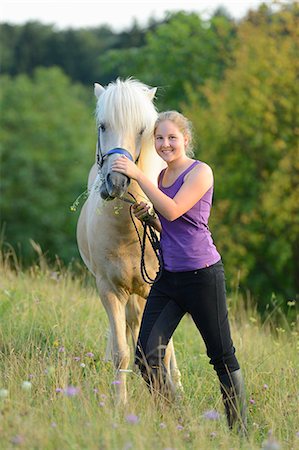 simsearch:853-06306120,k - Smiling girl with horse on meadow Stock Photo - Rights-Managed, Code: 853-06306120