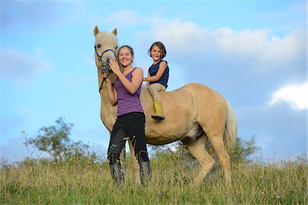 simsearch:853-06306120,k - Two girls with horse on meadow Stock Photo - Rights-Managed, Code: 853-06306123