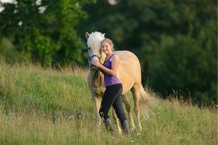simsearch:853-06306120,k - Smiling girl with horse on meadow Stock Photo - Rights-Managed, Code: 853-06306134
