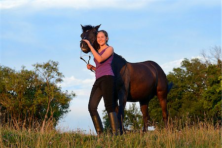 simsearch:853-06306120,k - Smiling girl with horse on meadow Stock Photo - Rights-Managed, Code: 853-06306137