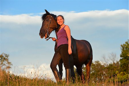 simsearch:853-06306120,k - Smiling girl with horse on meadow Stock Photo - Rights-Managed, Code: 853-06306130