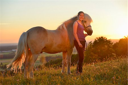 simsearch:853-06306120,k - Girl with horse on meadow at sunset Stock Photo - Rights-Managed, Code: 853-06306131
