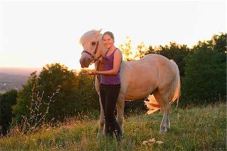 simsearch:853-06306120,k - Girl with horse on meadow at sunset Stock Photo - Rights-Managed, Code: 853-06306133