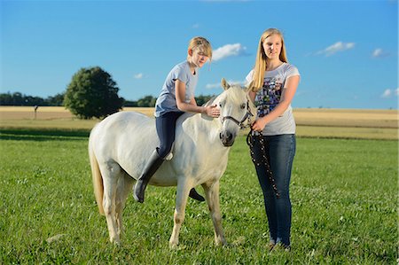 simsearch:853-06306120,k - Two girls with horse on meadow Stock Photo - Rights-Managed, Code: 853-06306140
