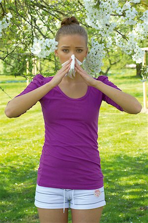 person blowing nose pic - Young woman blowing nose Stock Photo - Rights-Managed, Code: 853-06441400