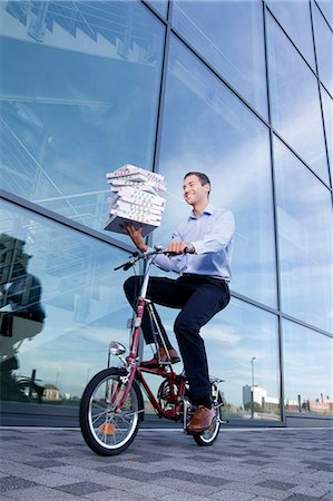 Man with pizza boxes on bike Stock Photo - Rights-Managed, Code: 853-06441613