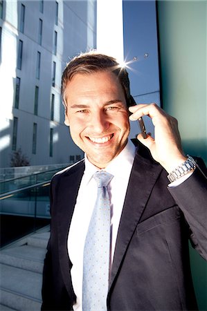simsearch:649-07520071,k - Smiling businessman on cell phone outdoors Stock Photo - Rights-Managed, Code: 853-06441624