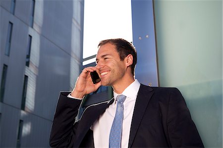 simsearch:649-07520071,k - Smiling businessman on cell phone outdoors Stock Photo - Rights-Managed, Code: 853-06441621