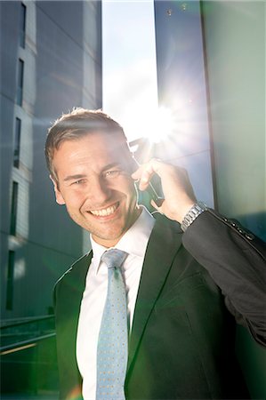 simsearch:649-07520071,k - Smiling businessman on cell phone outdoors Stock Photo - Rights-Managed, Code: 853-06441623