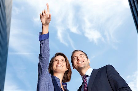 sky clothes - Businesswoman showing businessman something outdoors Stock Photo - Rights-Managed, Code: 853-06441704