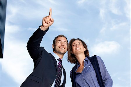 sky clothes - Businessman showing businesswoman something outdoors Stock Photo - Rights-Managed, Code: 853-06441705