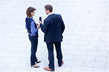 Businessman and businesswoman standing with cell phone outdoors Stock Photo - Rights-Managed, Code: 853-06441735