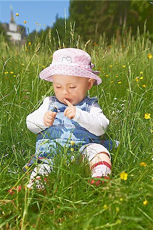 Female baby sitting in meadow with buttercups Stock Photo - Rights-Managed, Code: 853-06441921